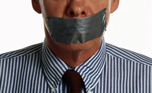 Businessman with Taped Mouth
